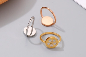 Detailed view of hollow cherry blossom disk rings in gold, rose gold and silver finish