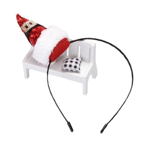 Christmas headband with mini red sequin Santa hat on a white miniature bench