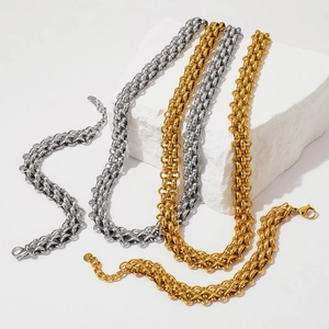 Detailed close-up of polished gold and silver titanium steel thick woven chain bracelets