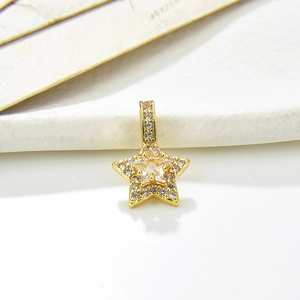 Detailed close-up of a gold star pendant featuring micro-pave zircons and center stone