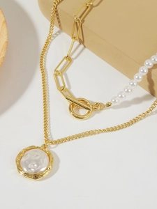 Close-up of double-layer baroque pearl necklace with gold chain and OT toggle clasp
