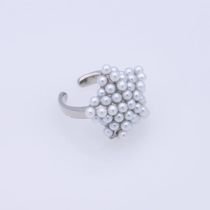 Macro shot of silver open ring featuring cluster of white pearls in star pattern