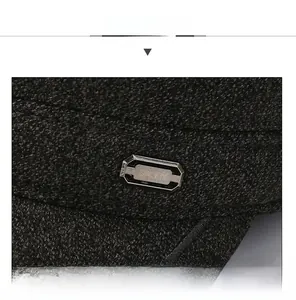 Close-up of wool flat cap texture with SPORT silver metal buckle and durable stitching