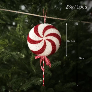 Close-up of red and white candy cane ornament with glitter on a green Christmas tree