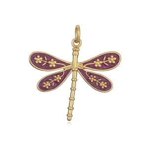 Macro detail of a dragonfly pendant with purple enamel wings and gold floral patterns