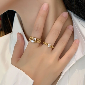 Close-up of 18K gold-plated cuban chain rings featuring pear and square zircon stones