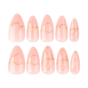Elegant almond press-on nails in nude pink with 3D gold bow and wire line accents