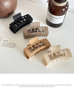 Close-up of four matte rectangular hair claws in black, coffee, camel, and beige