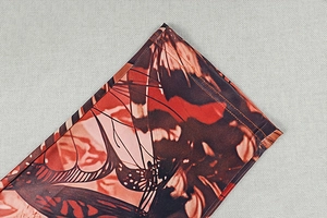 Detailed close-up showing double-needle stitching and red butterfly print on fabric