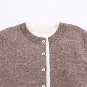 Brown knit cardigan with contrast round neck and button closure in a flat lay view