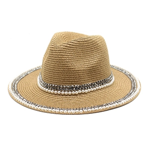 Detailed view of handmade pearl and rhinestone embellishments on a straw panama hat