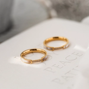 Golden titanium steel ring with white mother of pearl inlay and sparkling zircon crystals