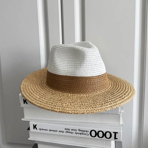 Minimalist wide-brim bicolor raffia straw hat with white crown and khaki brim on white stand