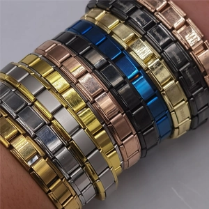 Close-up of multicolored stretch link bracelets featuring various metallic brushed finishes