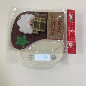 Detail showing the exact weight of the red Santa Christmas stocking with packaging