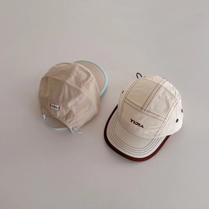 Detail of lightweight breathable mesh caps showing adjustable drawstring and branding