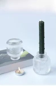 Close-up of ribbed glass candle holder with dual-use base for taper and tea lights
