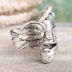Vintage silver floral spoon ring with intricate rose carvings and adjustable band