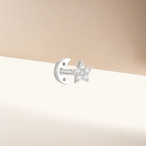 Detail of s925 silver stud earring featuring sparkling moon and star zircon design