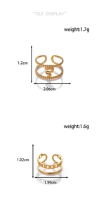 Detail showing two gold snake pattern and chain texture rings with size and weight specs