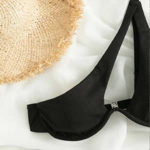 Detail of black ribbed bikini top with underwire support and silver front metal buckle