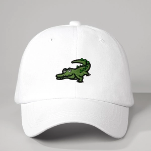 White cotton baseball cap with green cartoon crocodile embroidery and adjustable strap