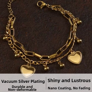 Detail of gold double-layer heart bracelet with chunky rectangular links and lobster clasp