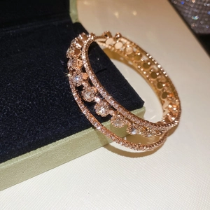 Detail of rose gold triple-layer bracelet with sparkling zircons on velvet jewelry box