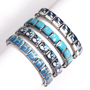 Detail of silver stretch bracelets with blue and white enamel sea theme patterns