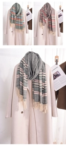 Detailed close-up of striped scarves with tassels in green, grey, and pink colorways