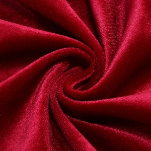 Macro detail of elegant deep red velvet fabric with soft spiral texture and luxury sheen