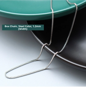 Macro detail of 1.2mm stainless steel box chain necklace with smooth metallic finish