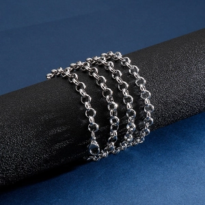 Silver stainless steel Rolo link necklace with lobster clasp on a black display pillar