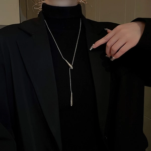 Detailed view of silver water drop pendant necklace styled on model with Y-shape chain