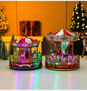 Close-up of LED Christmas carousel music box ornaments in large and small sizes