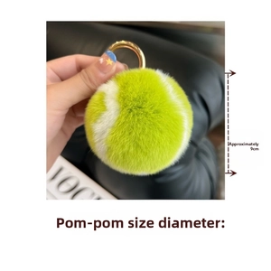 Detail of 9cm fluorescent green and white plush tennis ball keychain with gold ring