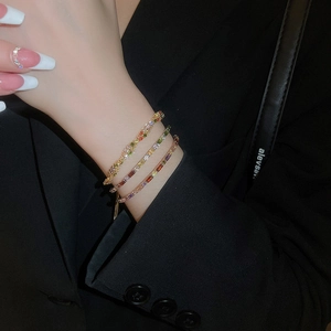Detailed close-up of a three-layer stacked bracelet featuring colorful zircon stones