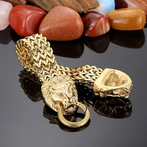 Macro shot of a golden lion head link bracelet with intricate metal textures and heavy chain