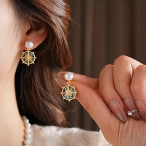 Gold plated mother of pearl stud earrings worn by model in a French vintage style
