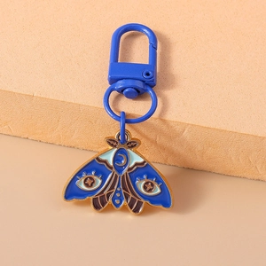 Detailed close-up of blue moth enamel keychain with gold trim and lobster clasp