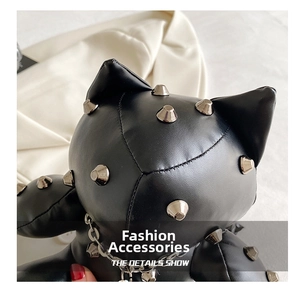 Detail shot of black PU leather cat bag featuring silver punk metal cone studs and chain