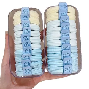 Two boxes of high elasticity hair ties in blue and beige with cute cartoon tags