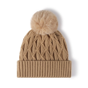 Winter khaki cable knit beanie for women with a fluffy faux fur pom-pom on top
