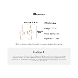 Detailed view of gold alloy cross drop earrings with dimensions of 8cm by 3.5cm