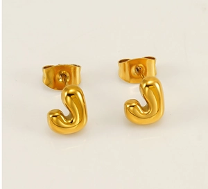 Close-up of polished 18K gold-plated bubble letter J stud earrings with butterfly backs
