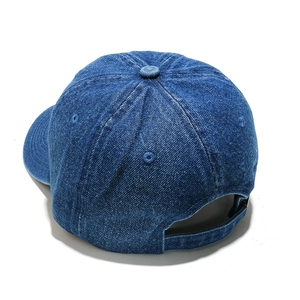 Detail view of the washed denim baseball cap with adjustable strap and embroidery