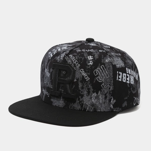 Detail of flat brim hip hop hat with 3D letter R embroidery and rebel graffiti print