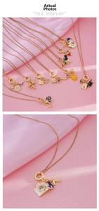 Macro shot of gold-plated pendant with sparkling zircon inlays on pink silk