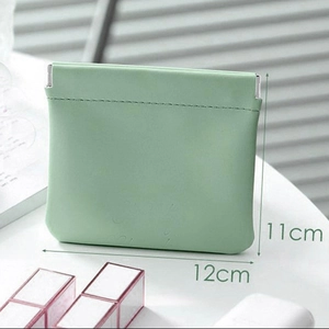 Detail view of light green pouch with metal closure showing 11cm by 12cm dimensions