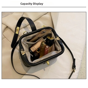 Top view showing the large capacity interior of a black vintage handbag with gold clasp